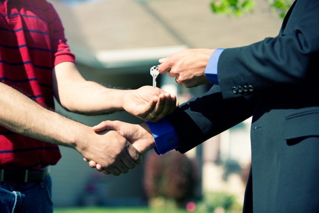 realtor giving keys to new home