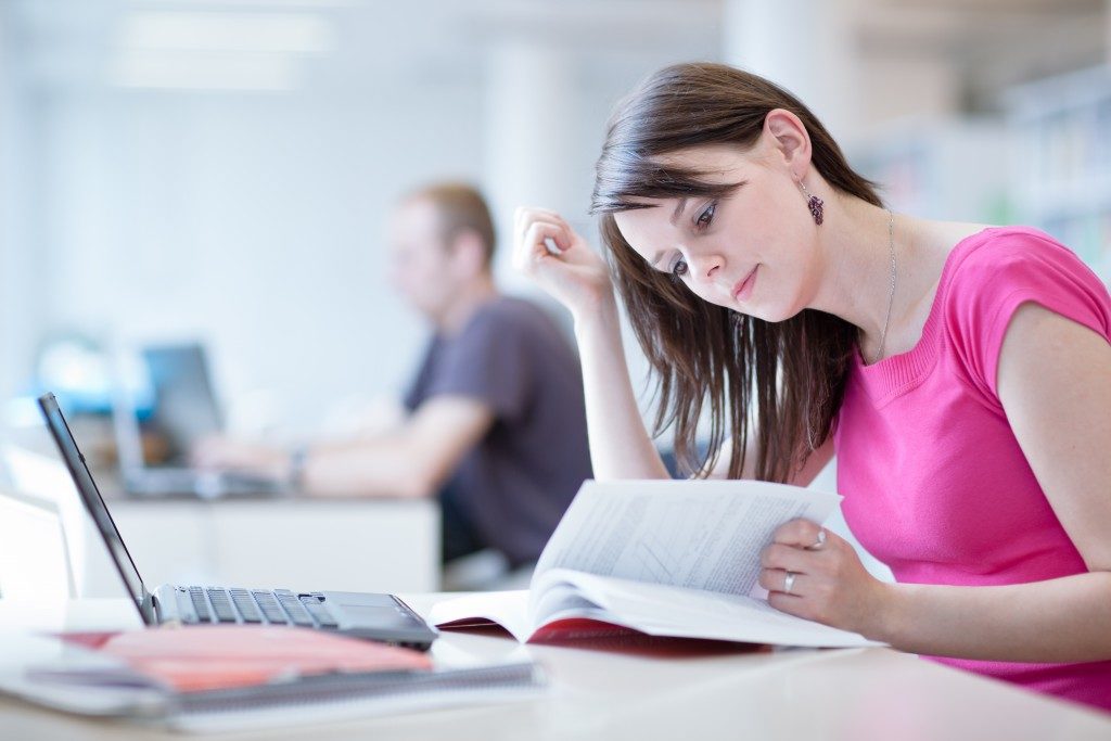 woman studying with her laptop in the library