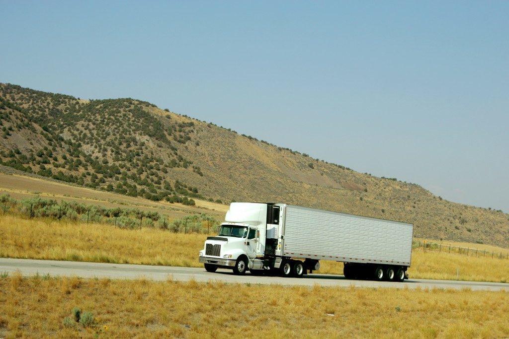 Semi truck going up hill on interstate highway