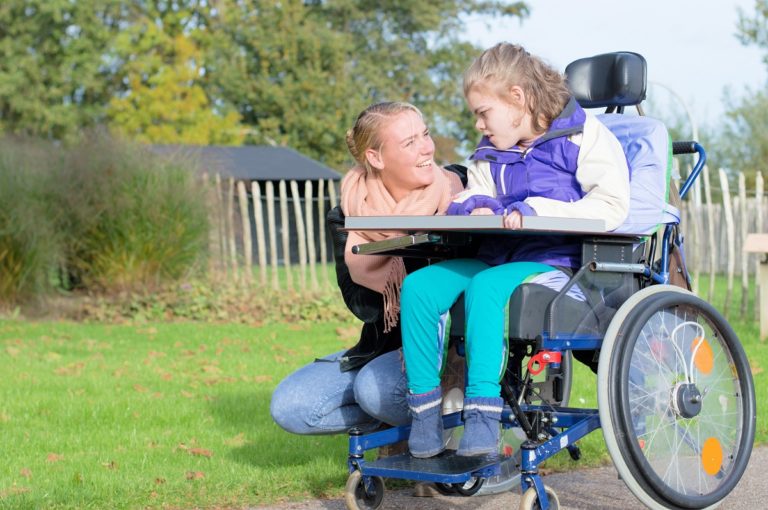 mother talking to her daughter in wheelchair