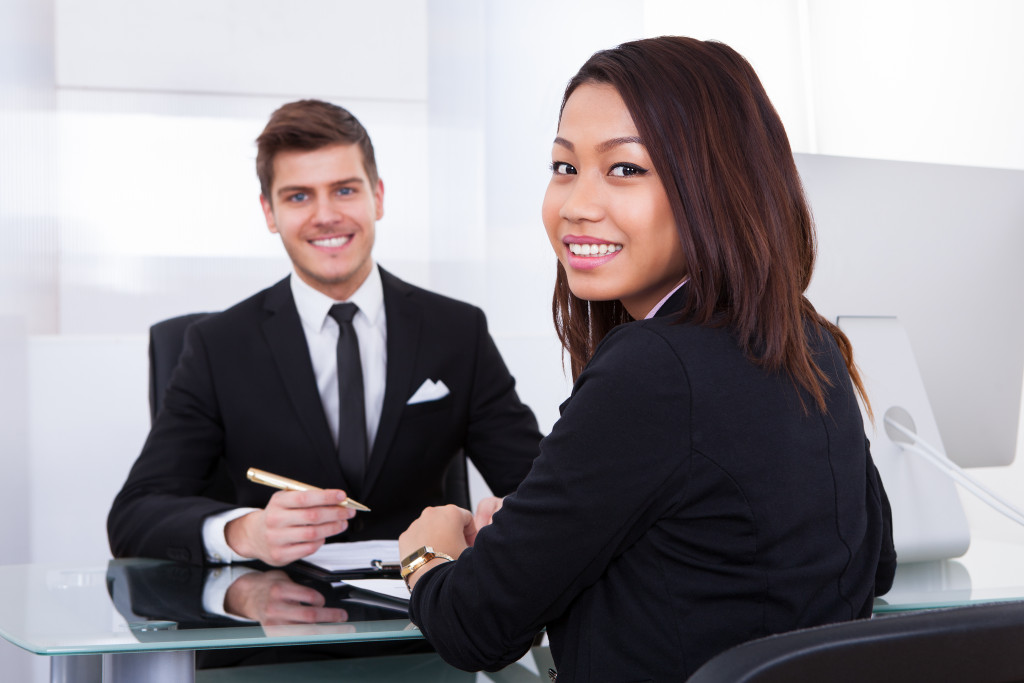 interviewer and applicant smiling