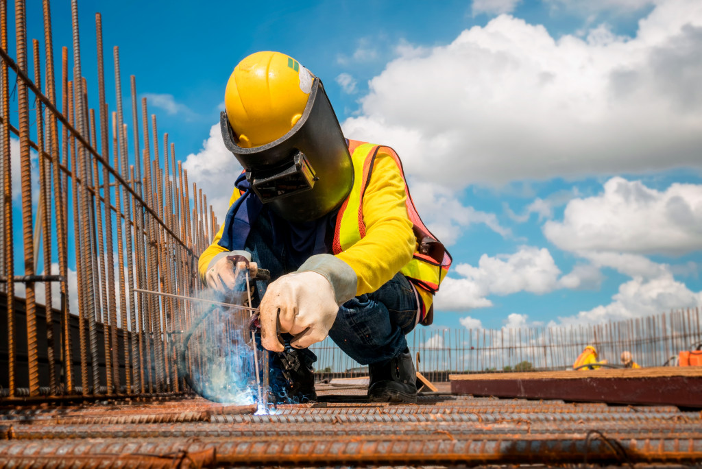 man doing welding in a construction