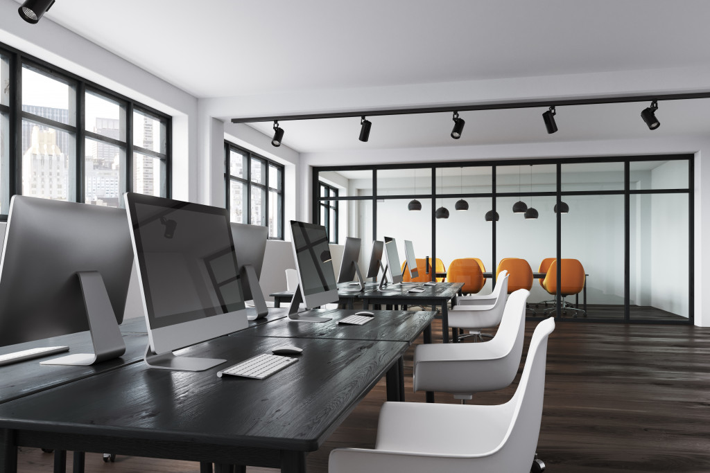 business office with monitors and office chairs for employees