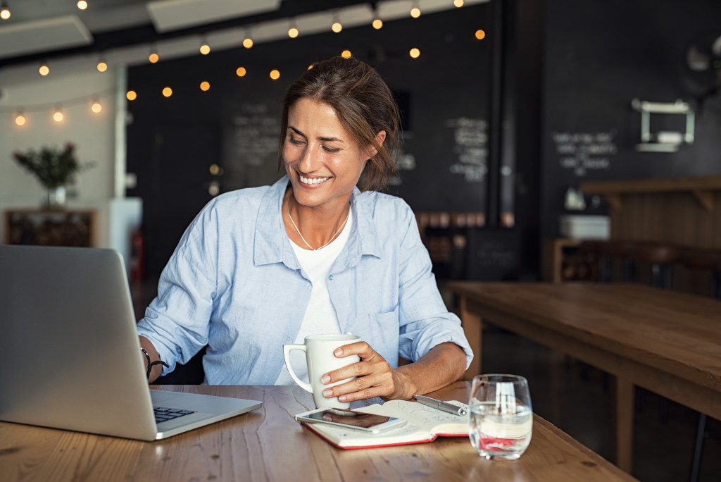 entrepreneur working on a coffee shop with laptop