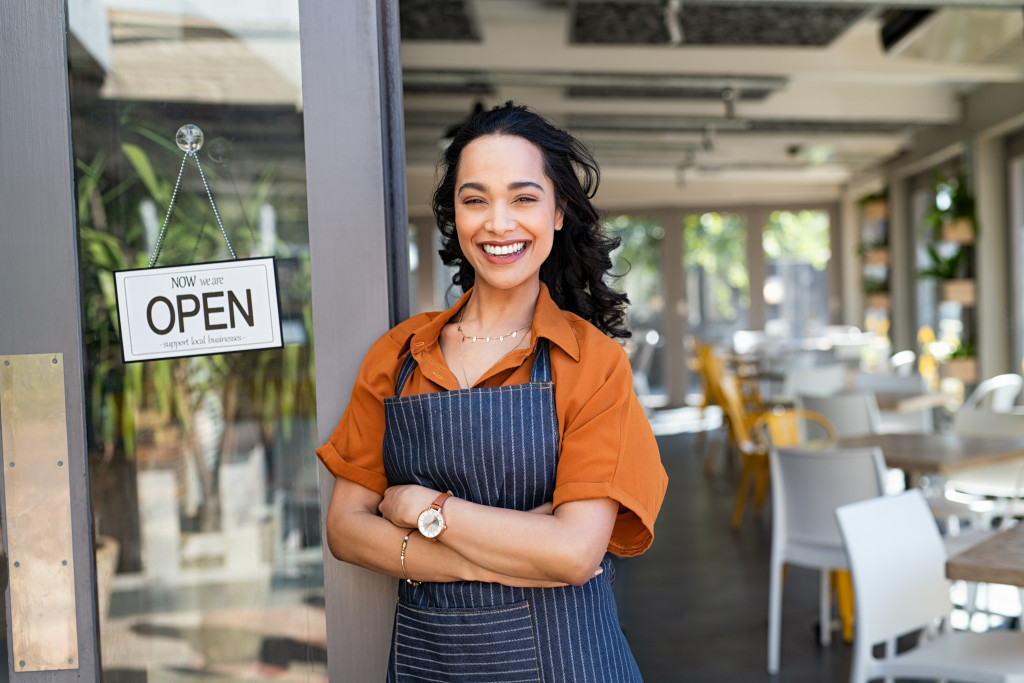 A woman in front of her business
