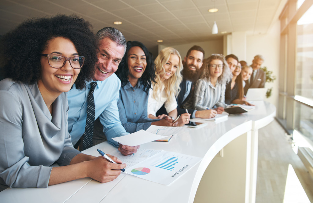 a row of smiling employees in an office