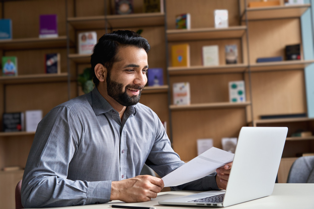 male employee working at home smiling