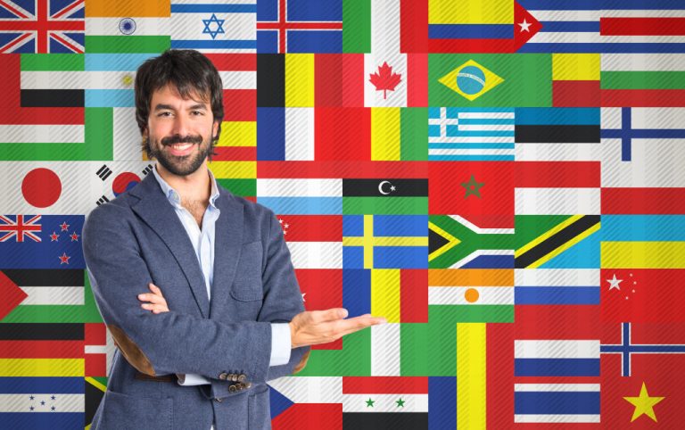 A businessman with various flags as his background
