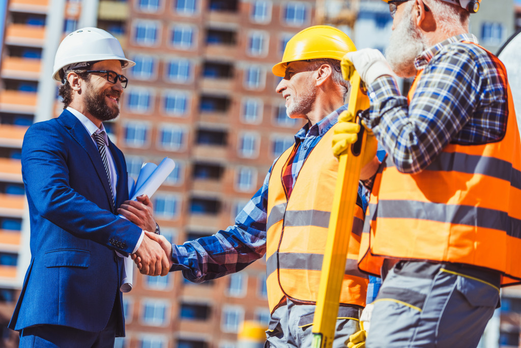 a construction man shaking hands with a professional