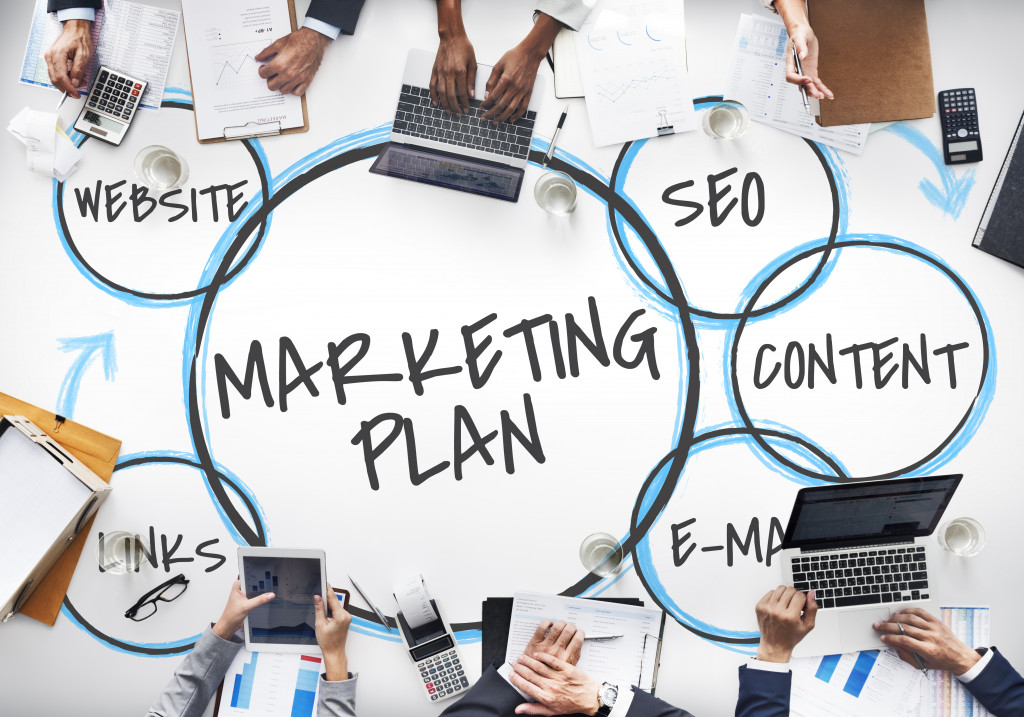 Marketing plan and related concepts on a table where business people work