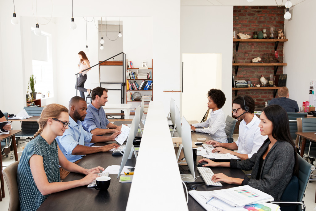 Employees busy working in their respective work spaces.