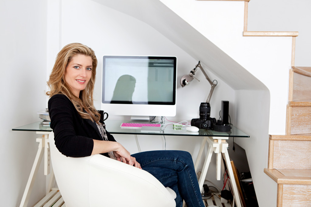 a woman sitting at her desk at home
