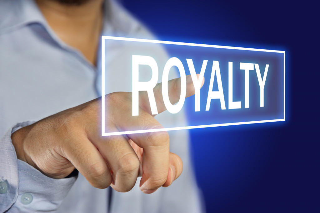 businessman pointing royalty on a screen