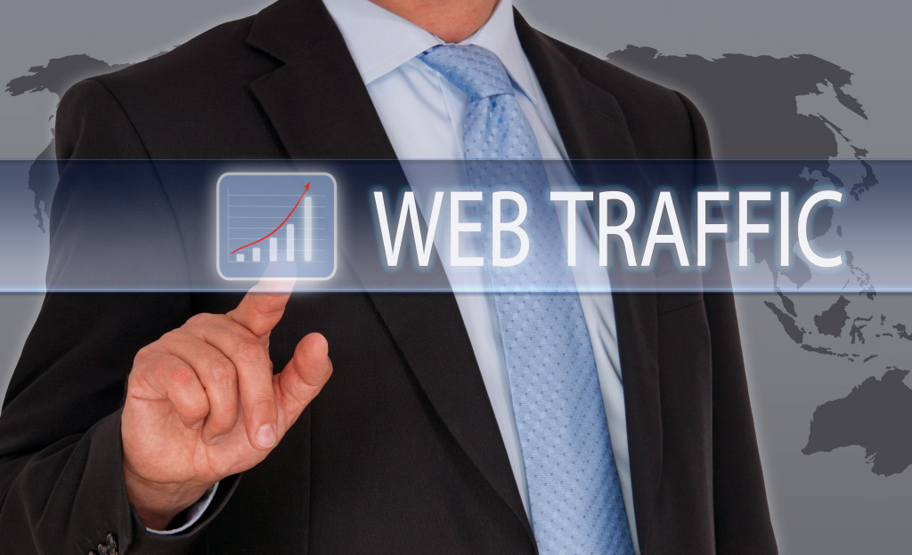 Executive clicking on a graph showing web traffic on a virtual screen.