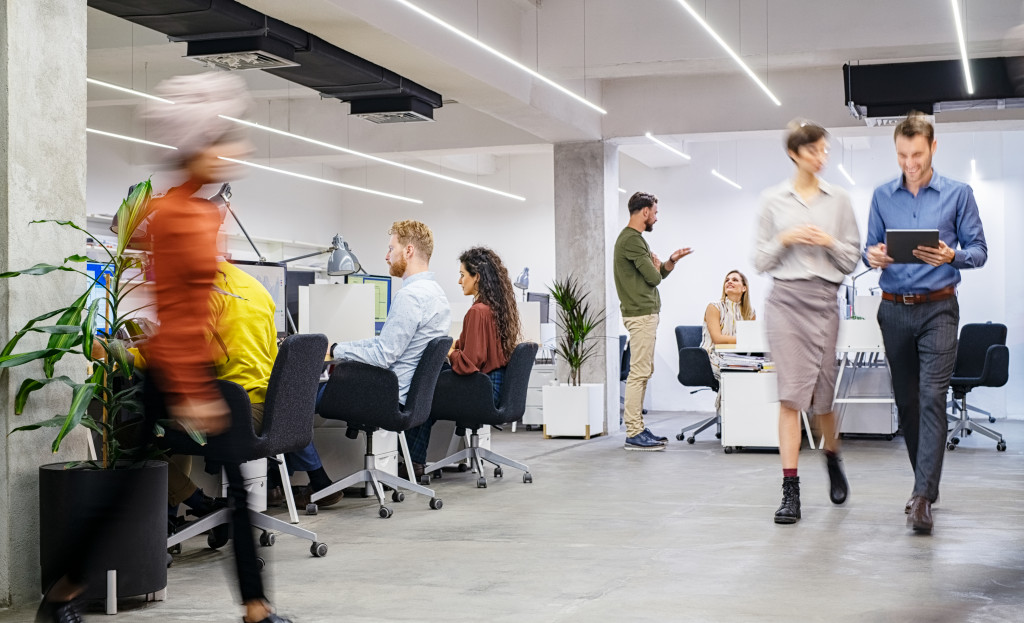 modern office with workers walking blurred